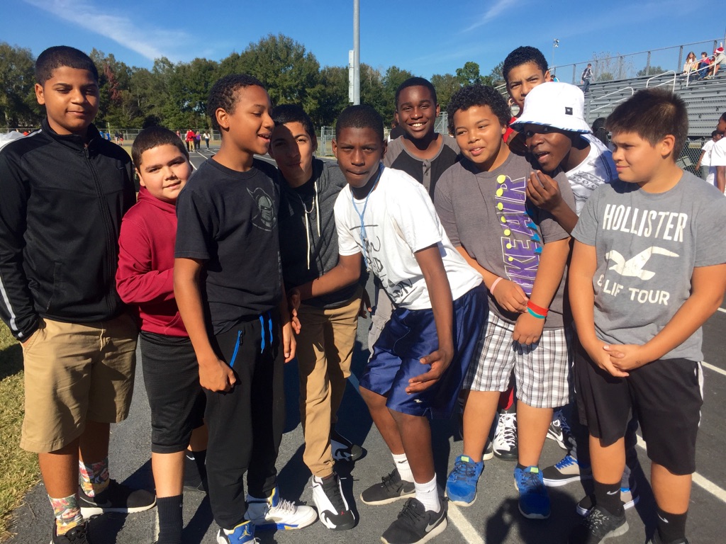 A group of boys pose for a picture as the walk-a-thon concludes after about an hour of walking the track. 